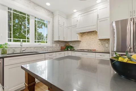 a kitchen with a counter space cabinets and a window