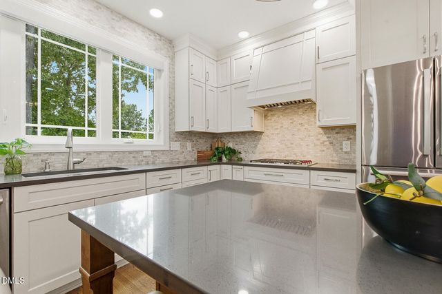 a kitchen with a counter space cabinets and a window