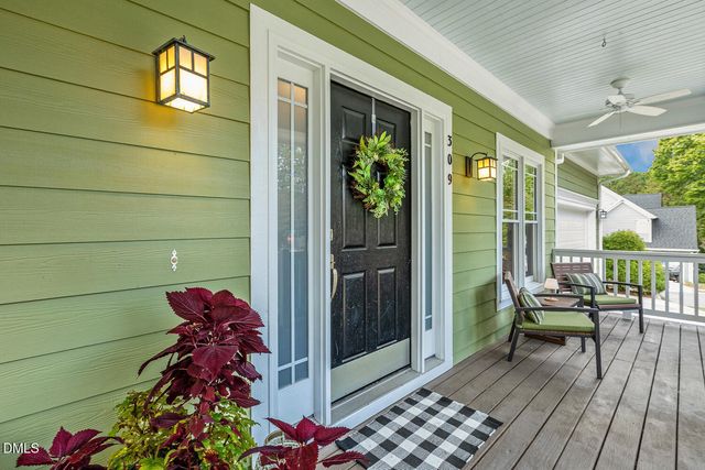 a living room with furniture and a flat screen tv with wooden floor