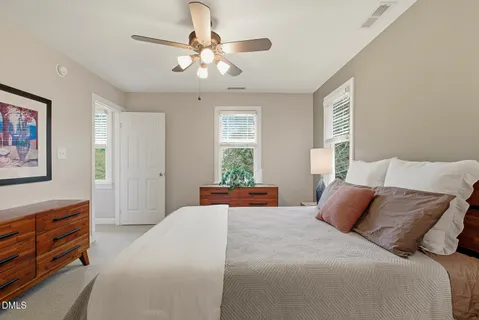 a bathroom with a double vanity sink toilet and a mirror