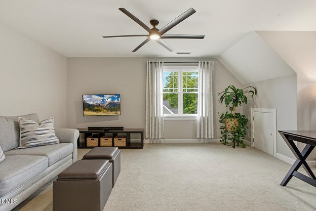 a view of a lake with a bench and trees
