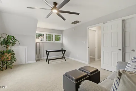 a view of house with backyard and outdoor seating