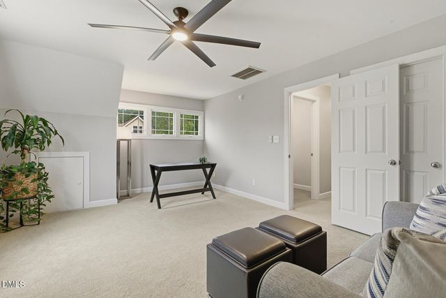 a view of house with backyard and outdoor seating
