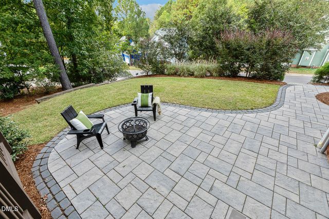 an aerial view of a house with a yard basket ball court and outdoor seating
