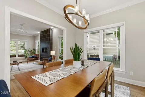 a living room with dining table and a couches chair
