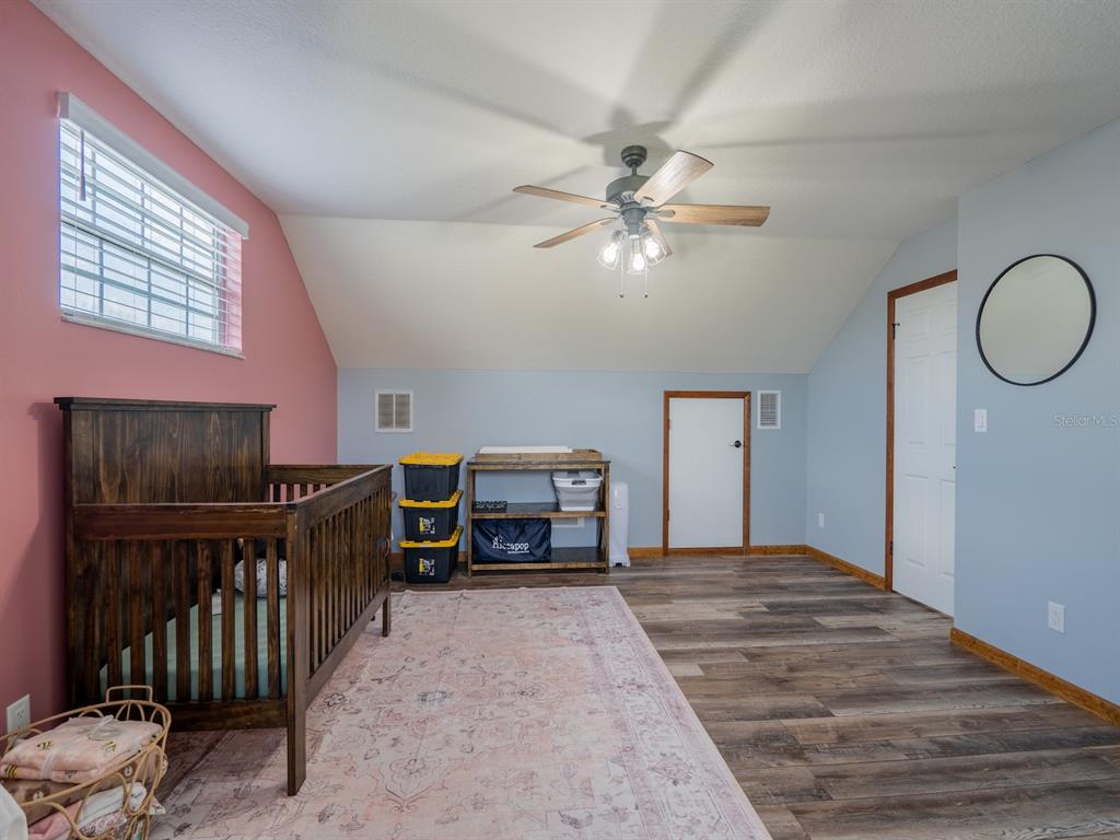 4381 Northeast 105th Place Anthony, FL 32617 - Photo 30 of 49 a bedroom with furniture and window