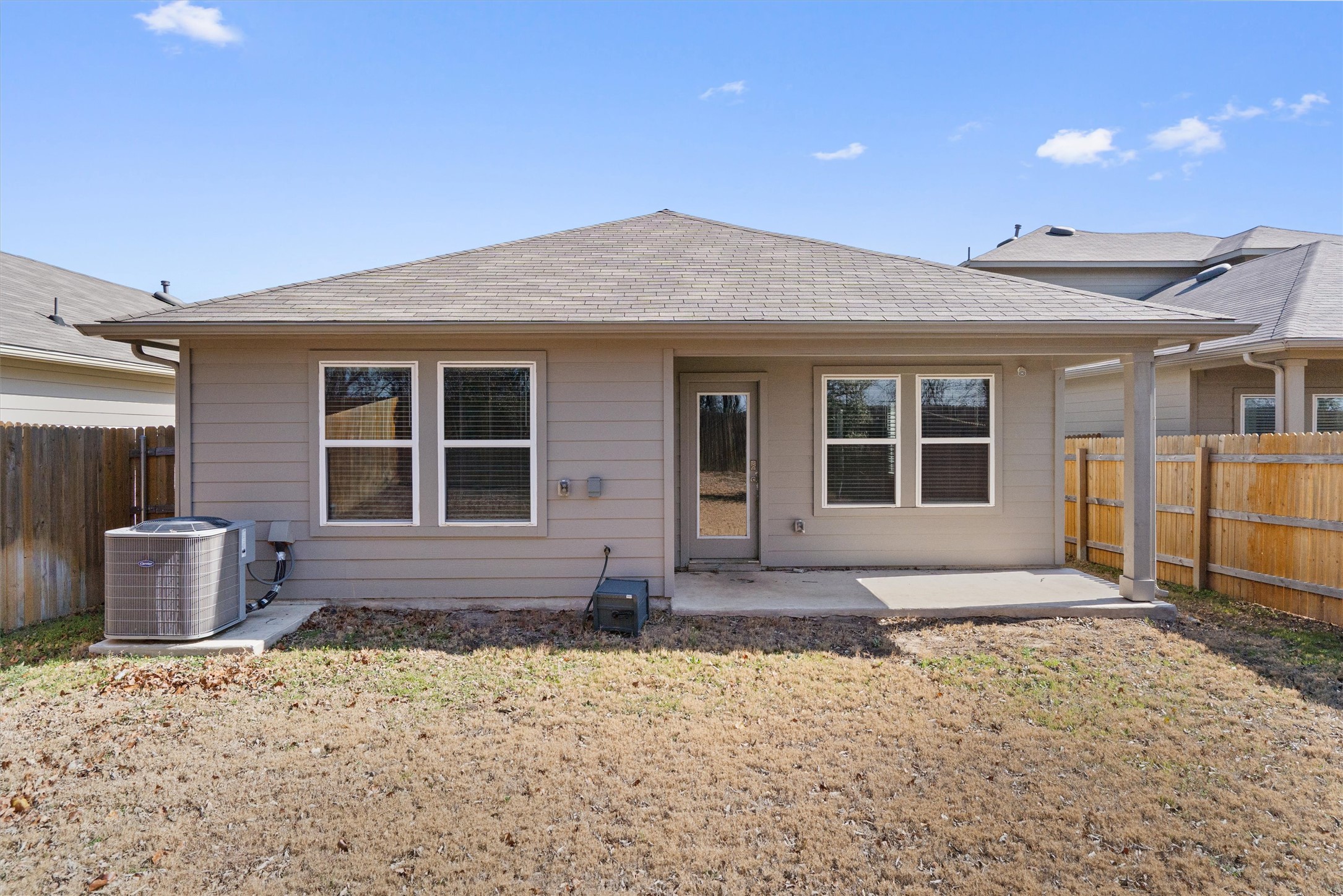 352 Sickle Loop Uhland, TX 78640 - Photo 32 of 36 Rear exterior view showing covered patio and fenced yard.