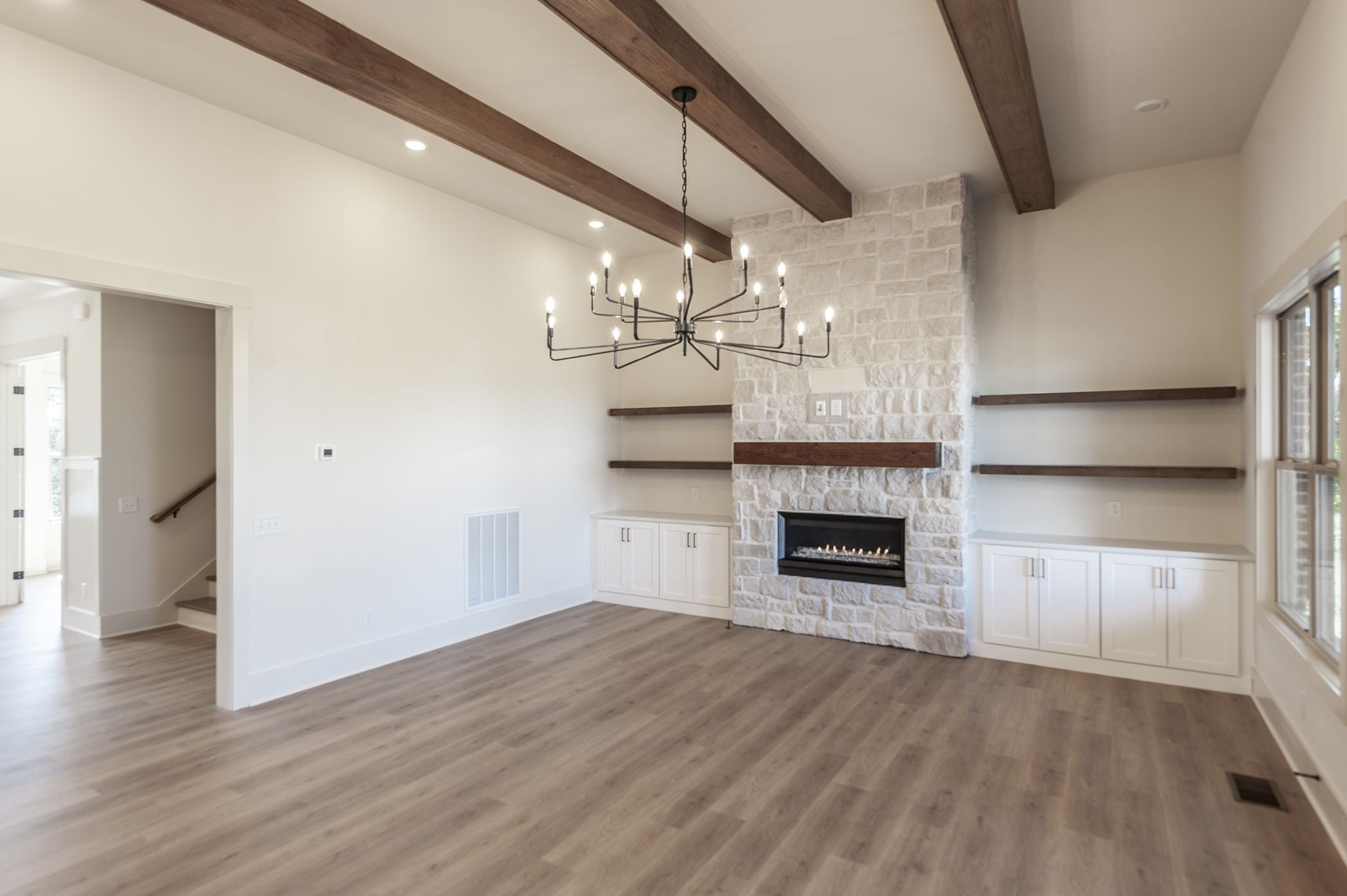 339 Raintree Drive Hendersonville, TN 37075 - Photo 23 of 53 a view of a livingroom with a fireplace a chandelier and stairs