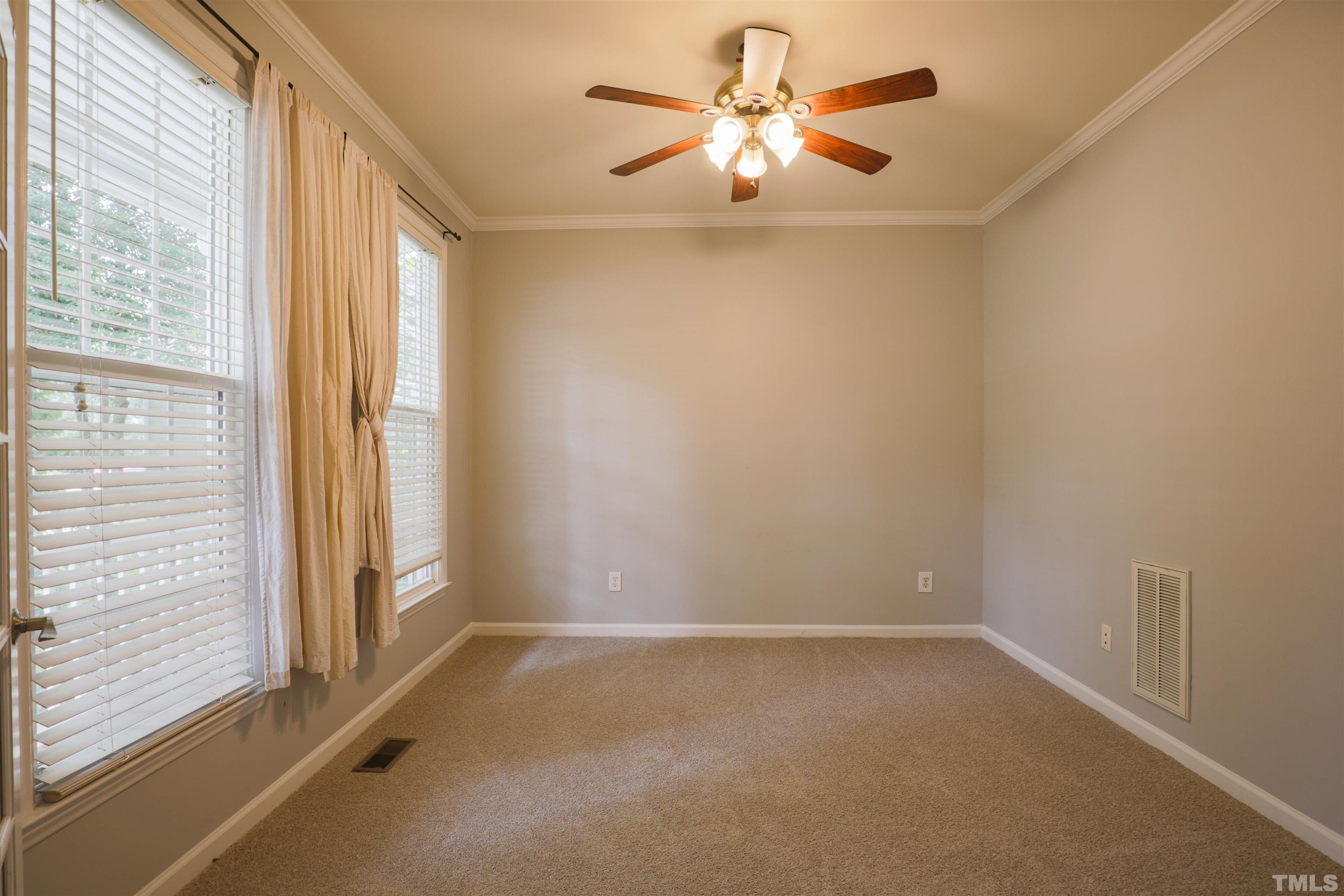 4709 Treadstone Court Raleigh, NC 27616 - Photo 13 of 22 an empty room with windows and fan