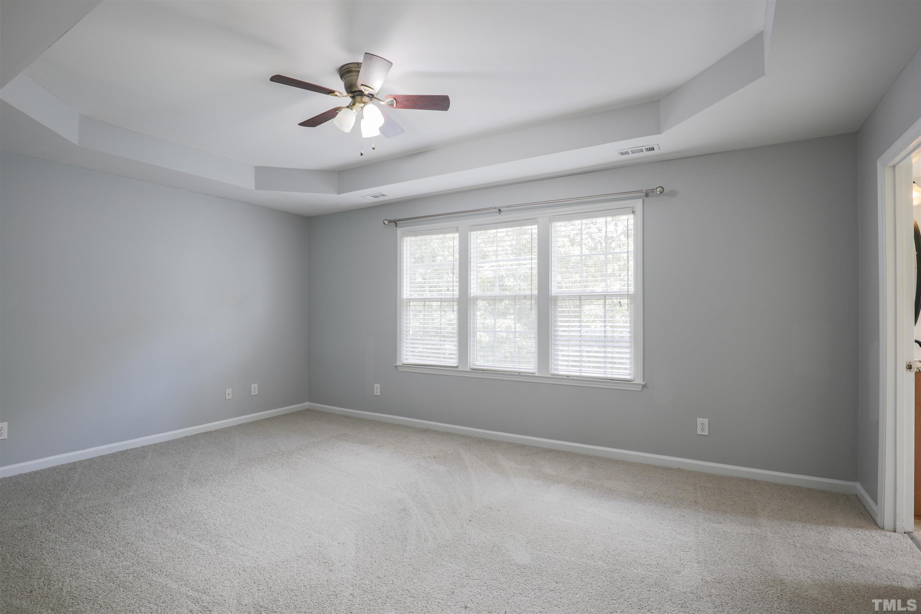 4709 Treadstone Court Raleigh, NC 27616 - Photo 14 of 22 an empty room with a window and a fan
