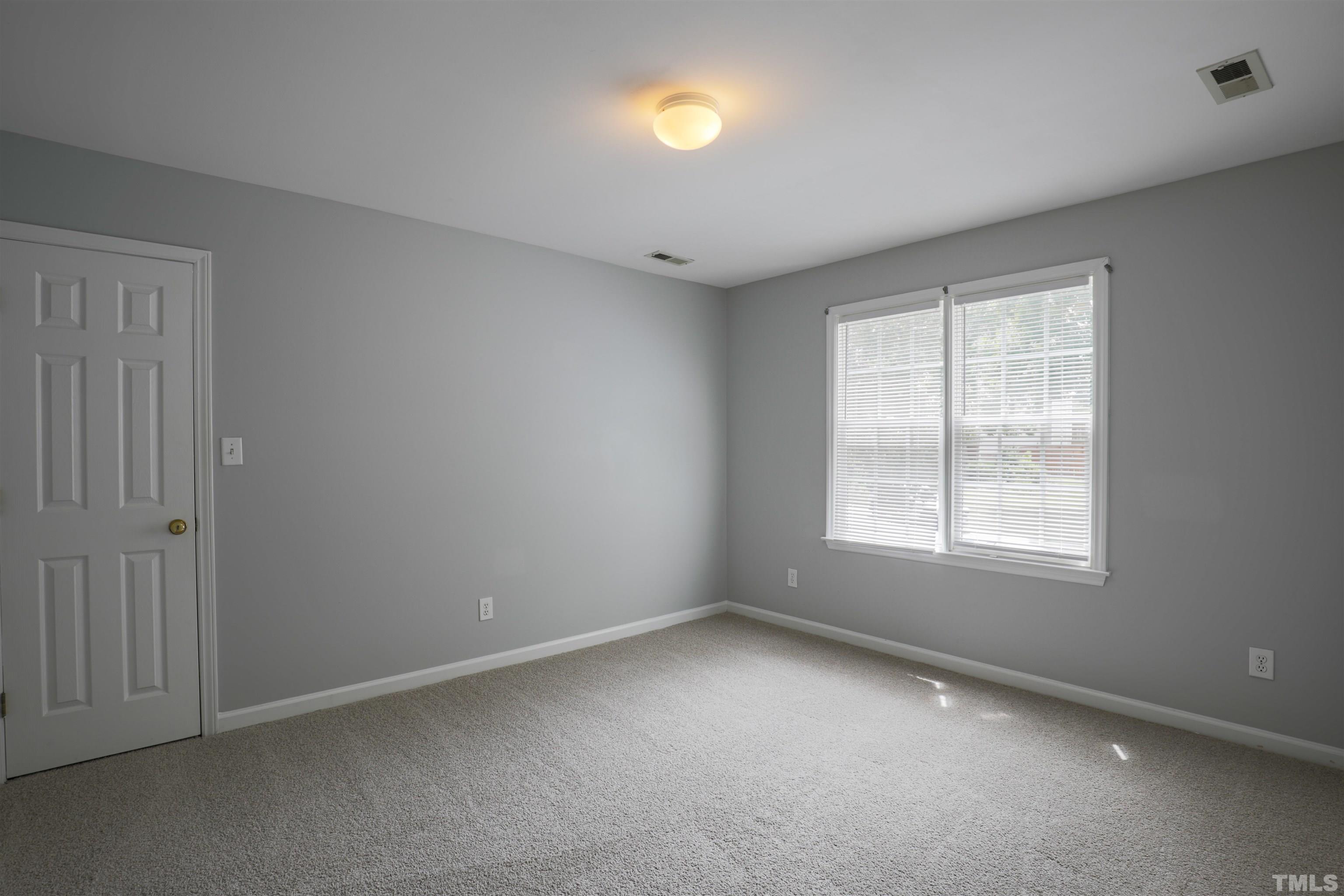 4709 Treadstone Court Raleigh, NC 27616 - Photo 17 of 22 an empty room with a window