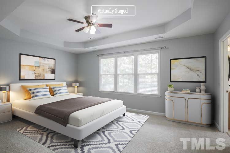 4709 Treadstone Court Raleigh, NC 27616 - Photo 3 of 22 a bedroom with a large bed and a chandelier
