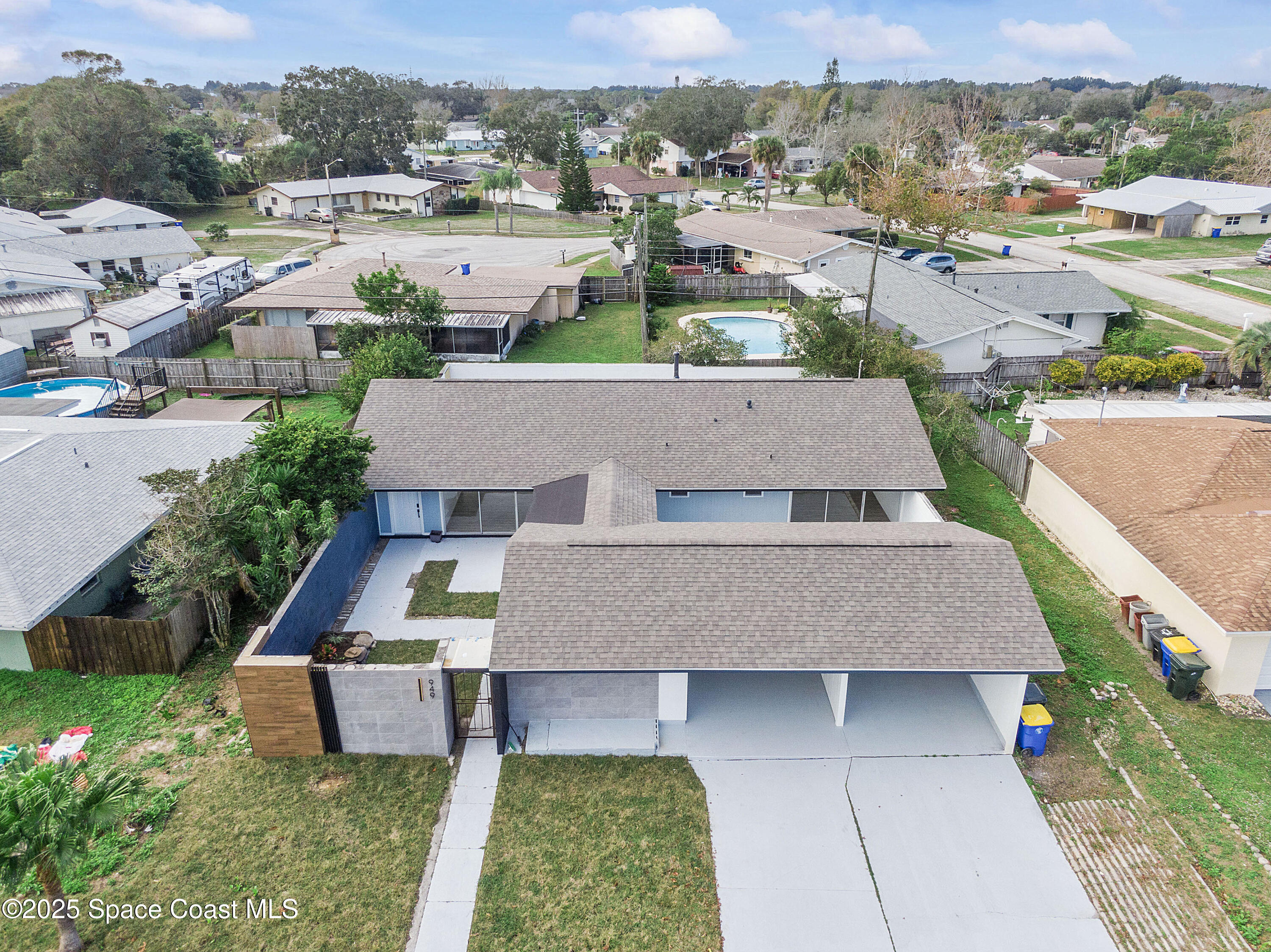 949 Levitt Parkway Rockledge, FL 32955 - Photo 11 of 52 an aerial view of a house with swimming pool and a yard