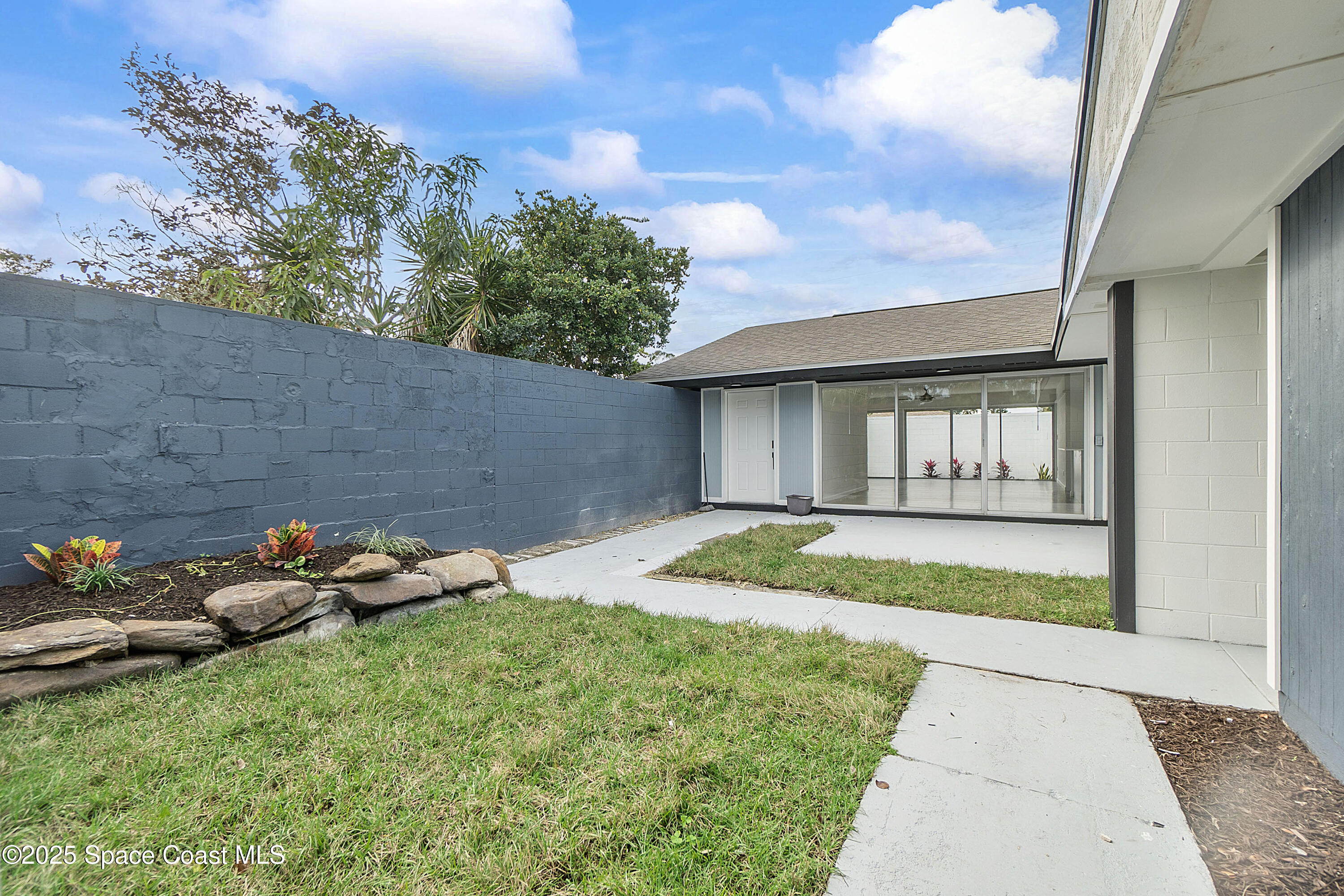 949 Levitt Parkway Rockledge, FL 32955 - Photo 16 of 52 a backyard of a house with lots of green space