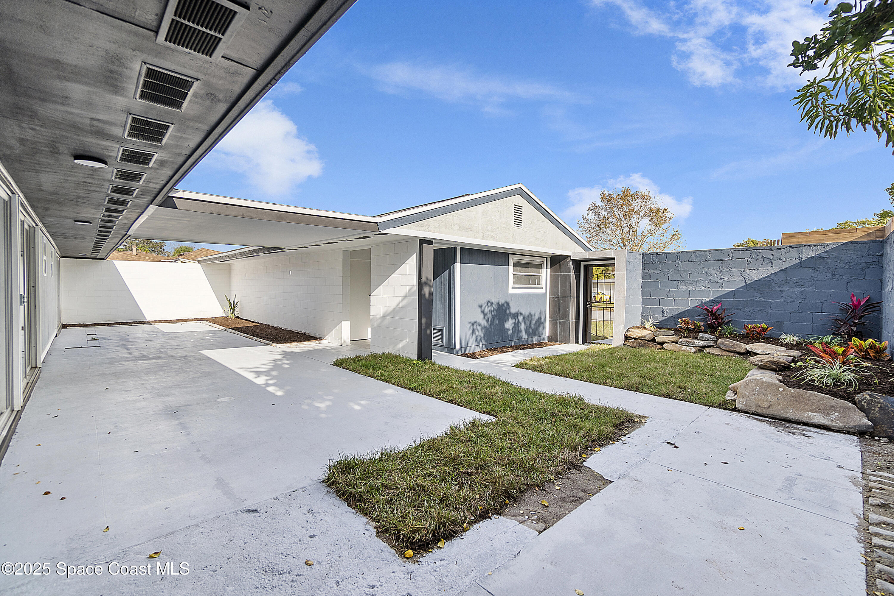 949 Levitt Parkway Rockledge, FL 32955 - Photo 20 of 52 a front view of a house with a yard and garage