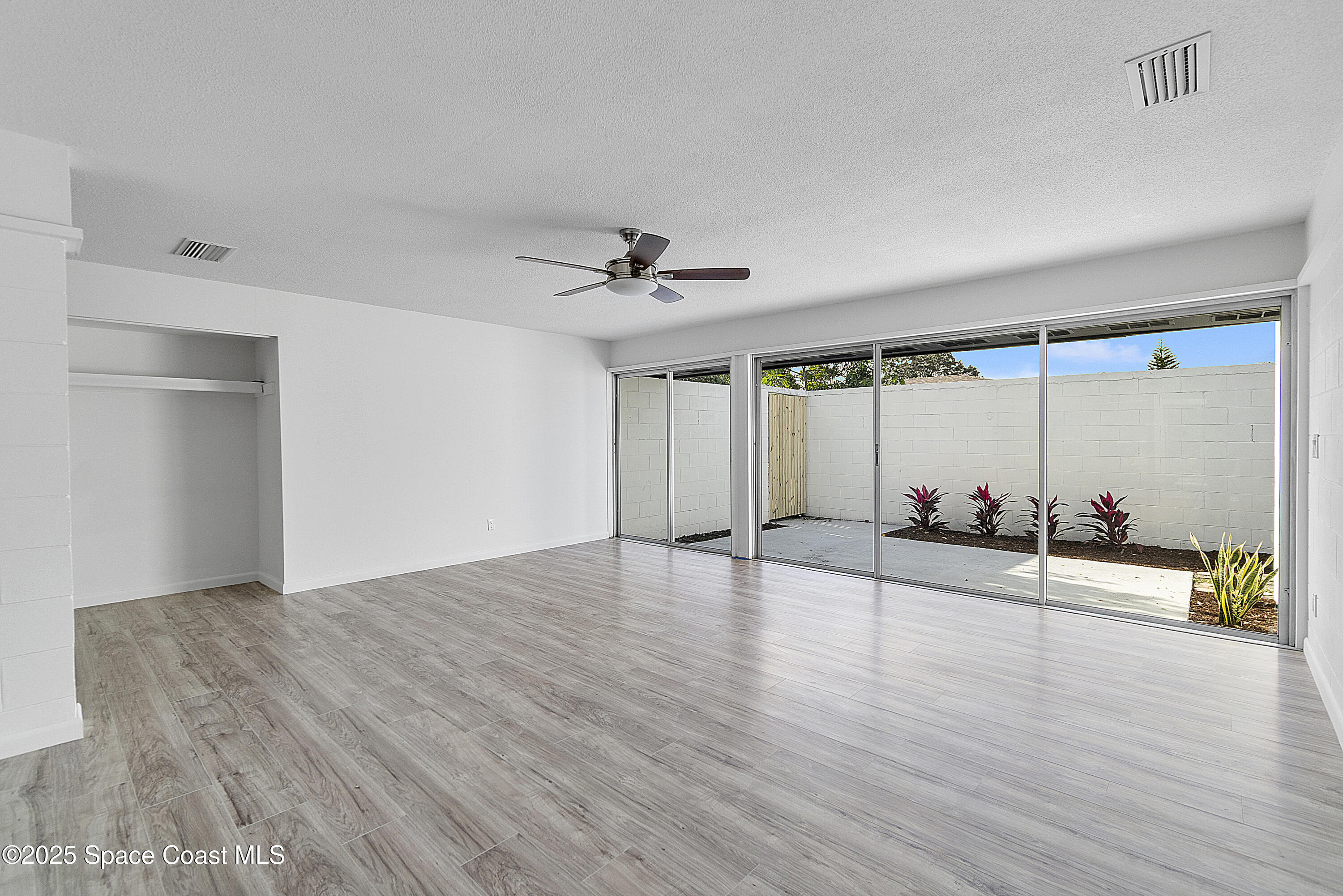 949 Levitt Parkway Rockledge, FL 32955 - Photo 30 of 52 an empty room with wooden floor and windows