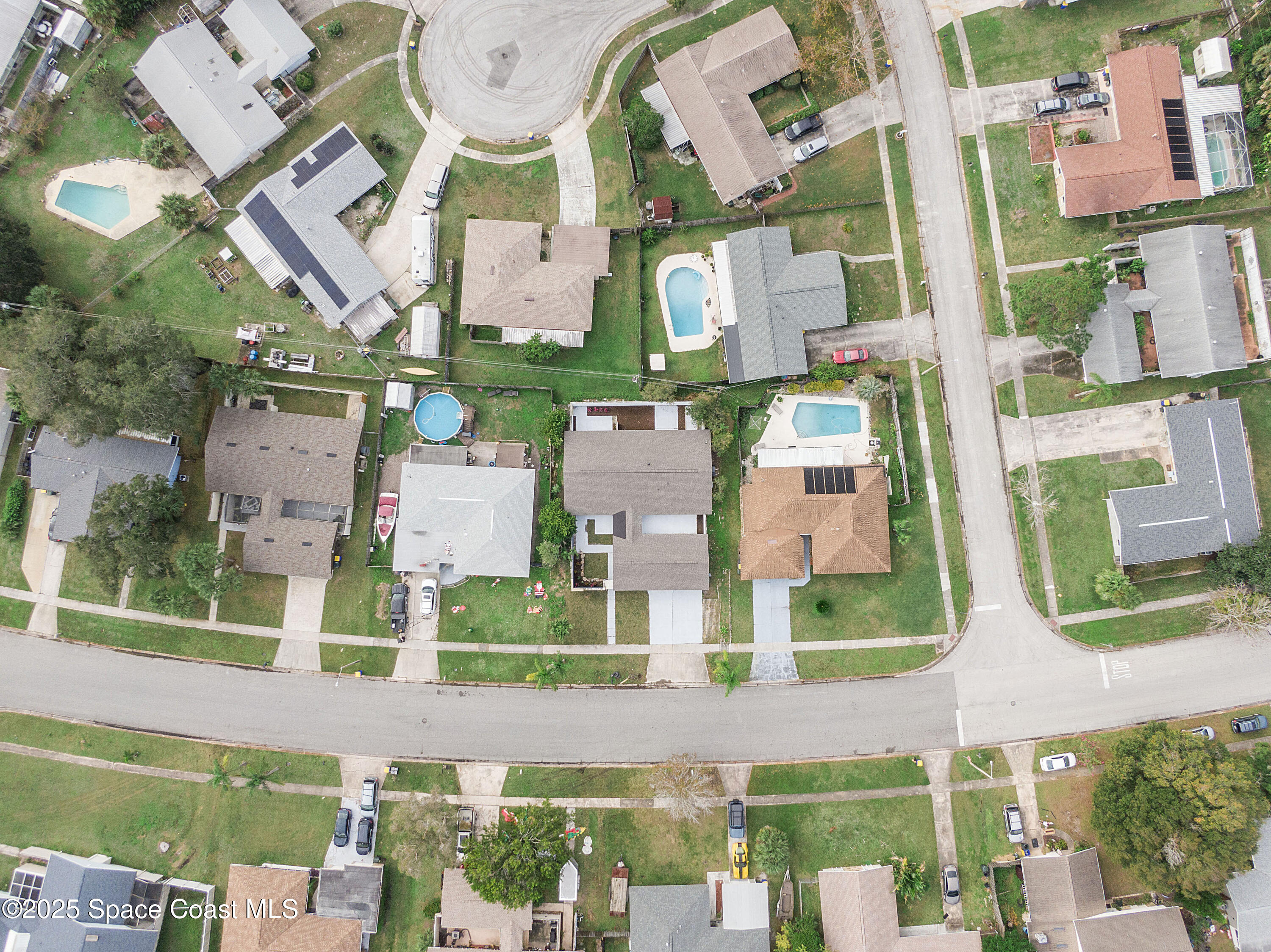 949 Levitt Parkway Rockledge, FL 32955 - Photo 3 of 52 an aerial view of multiple houses with a yard