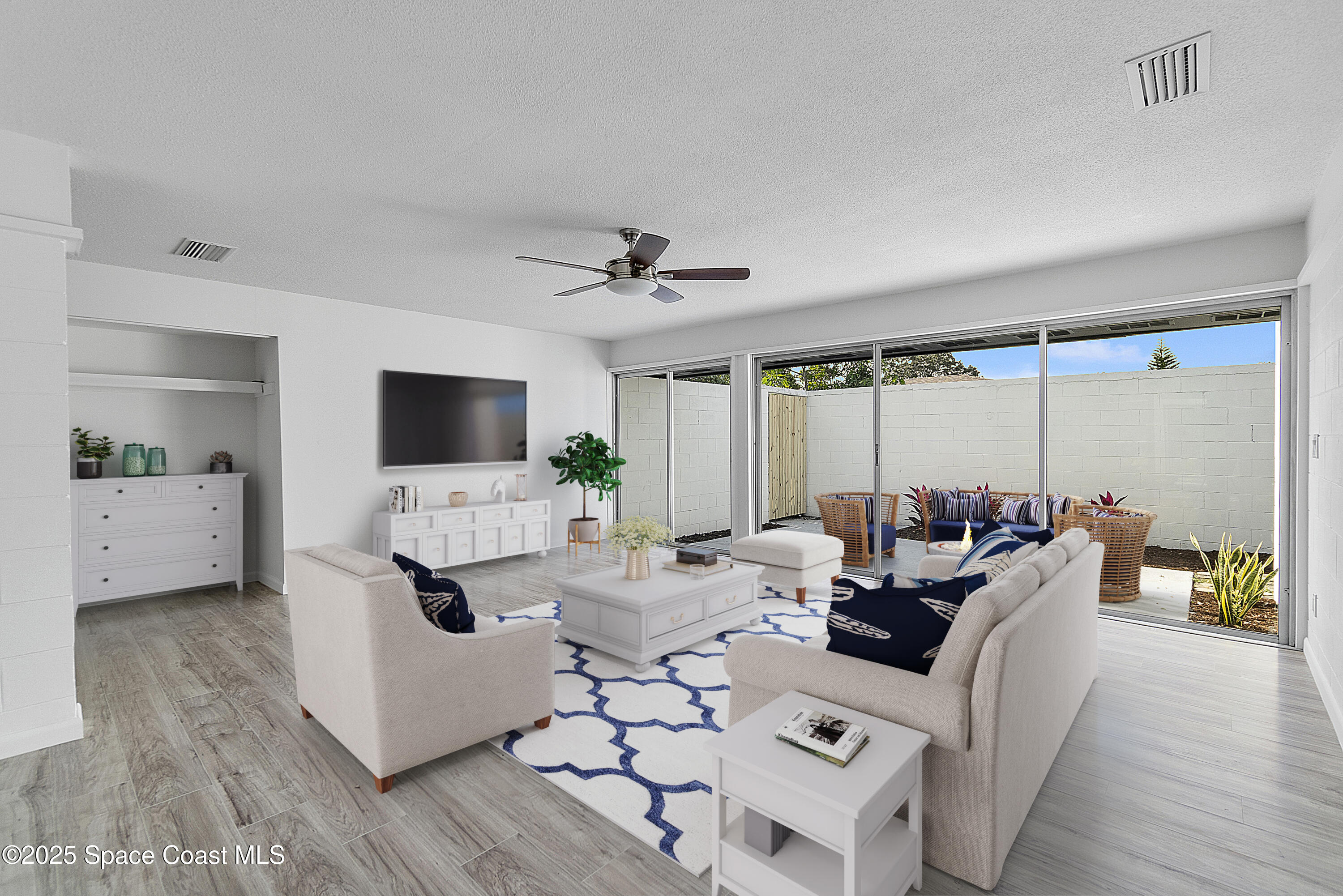 949 Levitt Parkway Rockledge, FL 32955 - Photo 31 of 52 a living room with furniture a flat screen tv and a large window