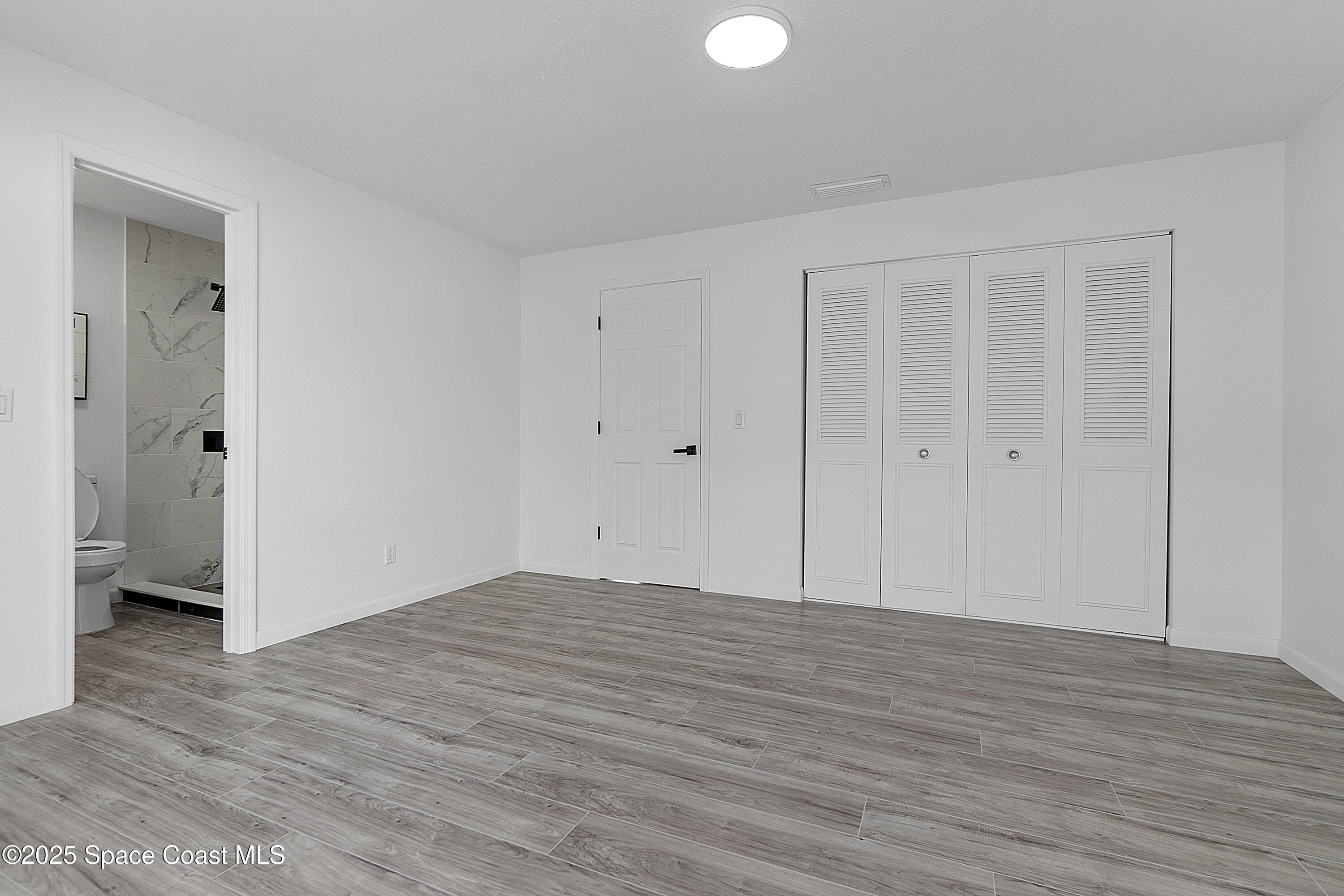 949 Levitt Parkway Rockledge, FL 32955 - Photo 42 of 52 a view of an empty room with wooden floor