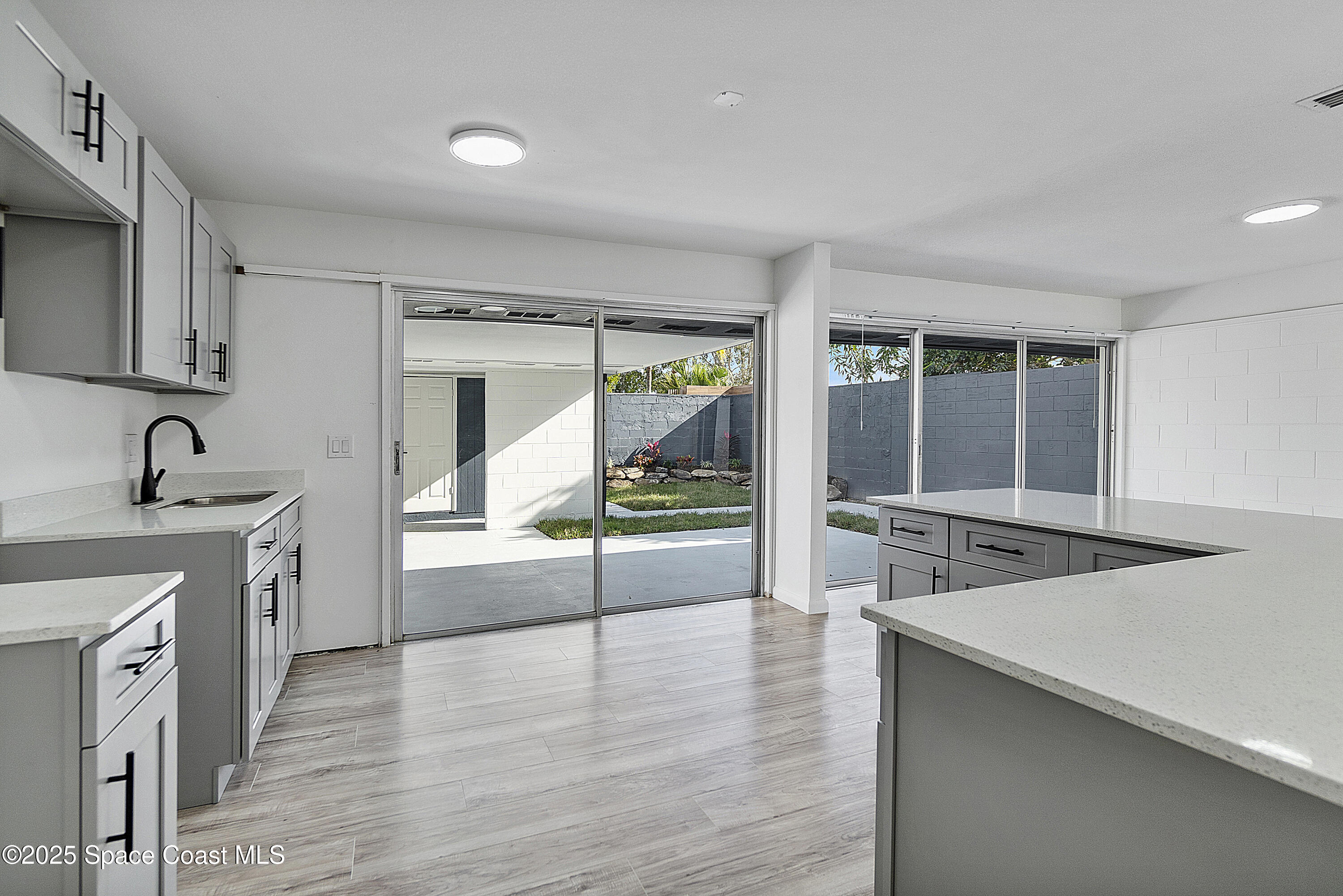949 Levitt Parkway Rockledge, FL 32955 - Photo 46 of 52 a hallway with sink and wooden floor