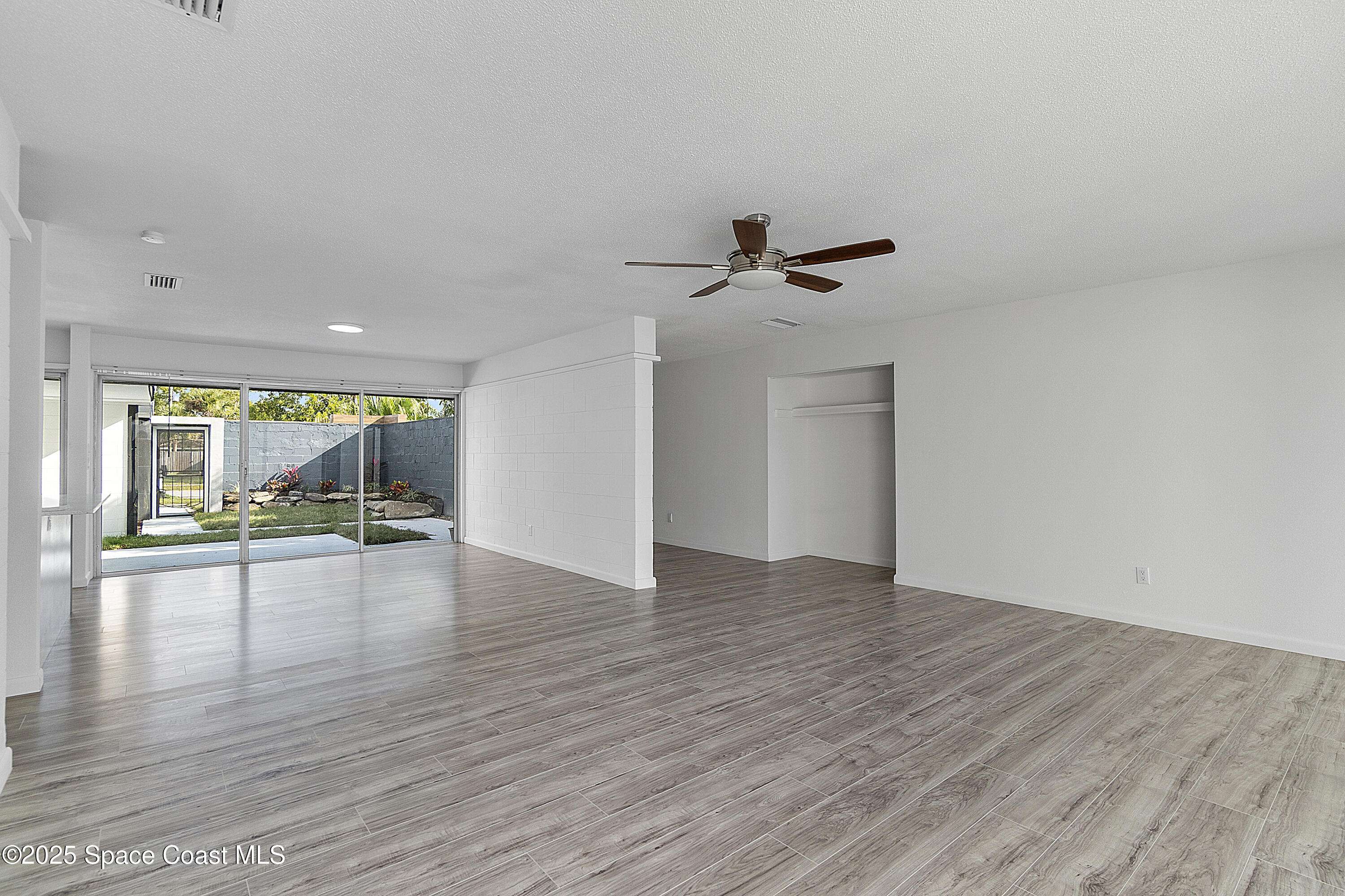 949 Levitt Parkway Rockledge, FL 32955 - Photo 47 of 52 a view of empty room with wooden floor and fan