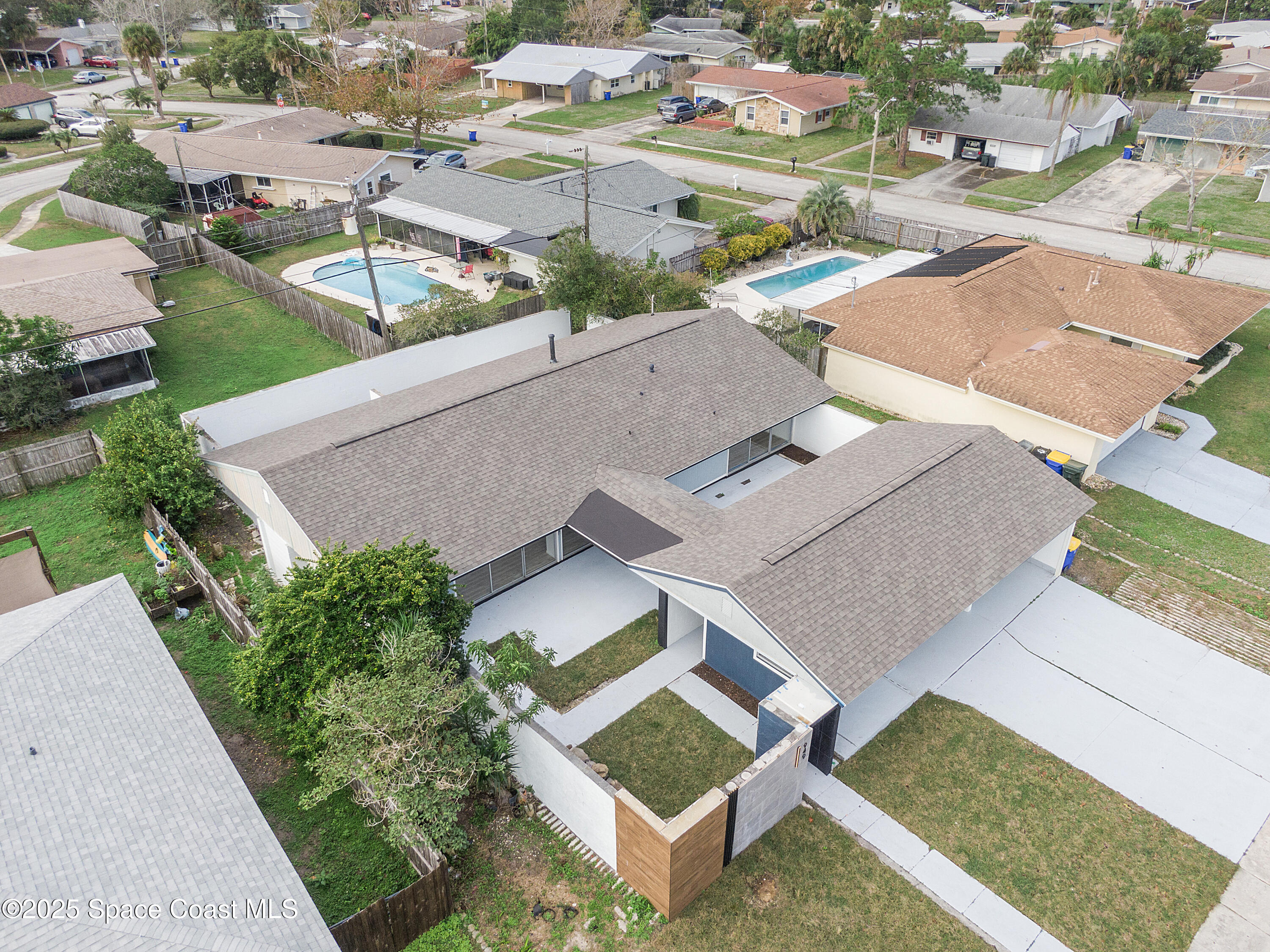 949 Levitt Parkway Rockledge, FL 32955 - Photo 9 of 52 an aerial view of residential houses with outdoor space and parking