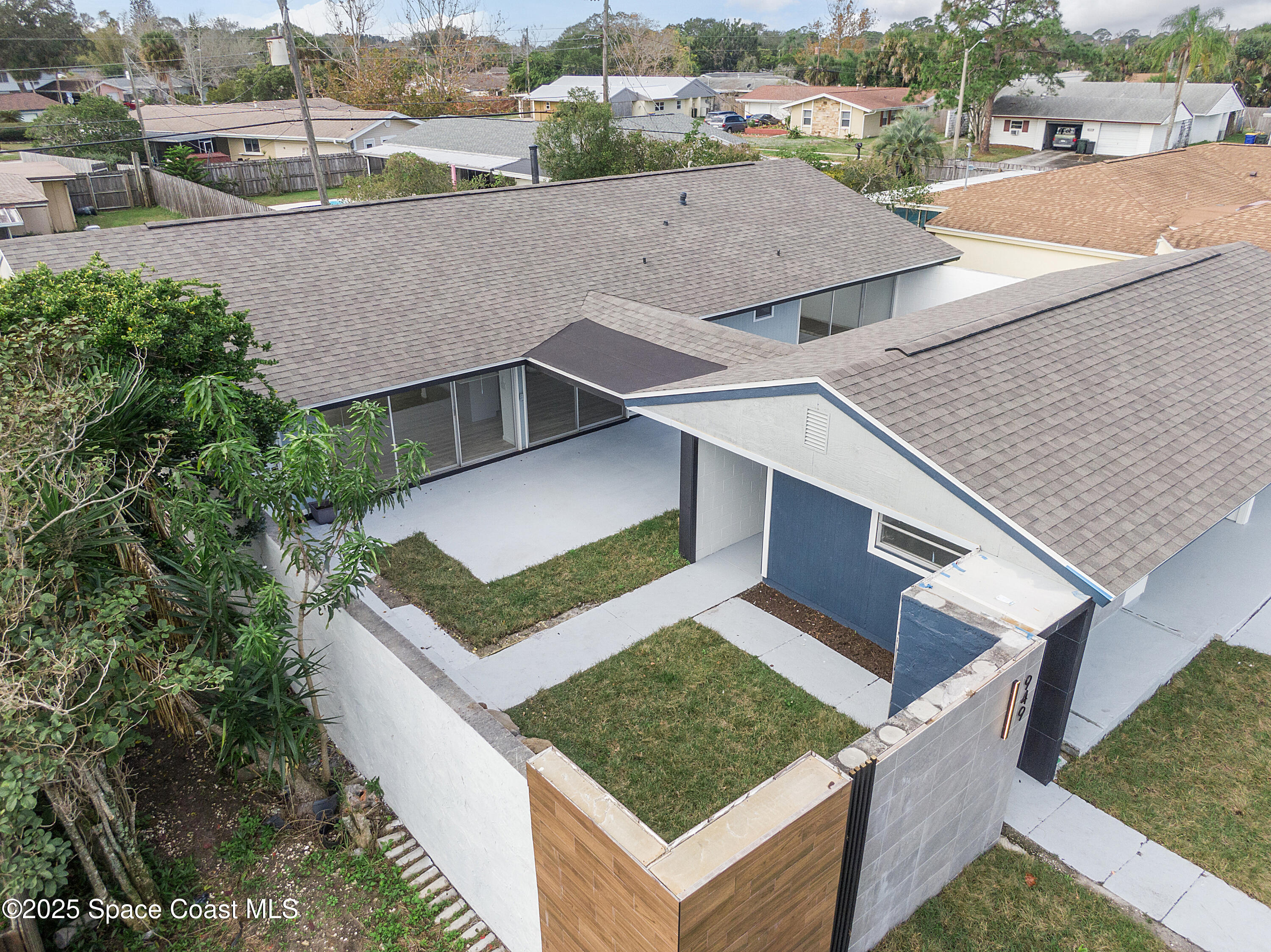 949 Levitt Parkway Rockledge, FL 32955 - Photo 10 of 52 an aerial view of a house with a yard garage and lake view in back