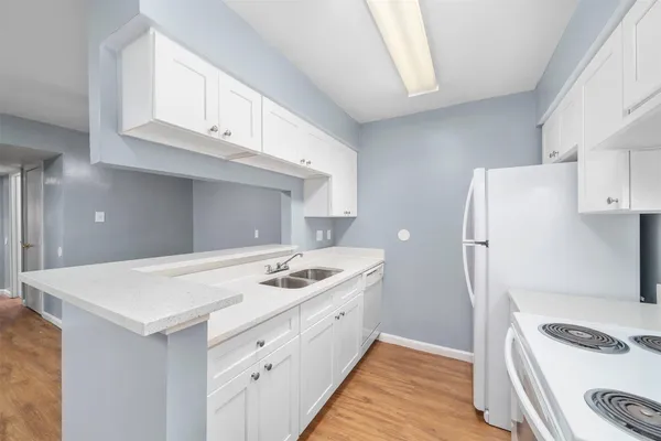 a kitchen with a sink stove and refrigerator