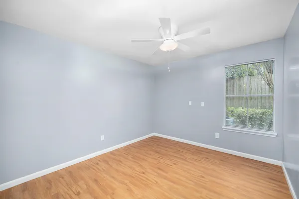 wooden floor in an empty room with a window