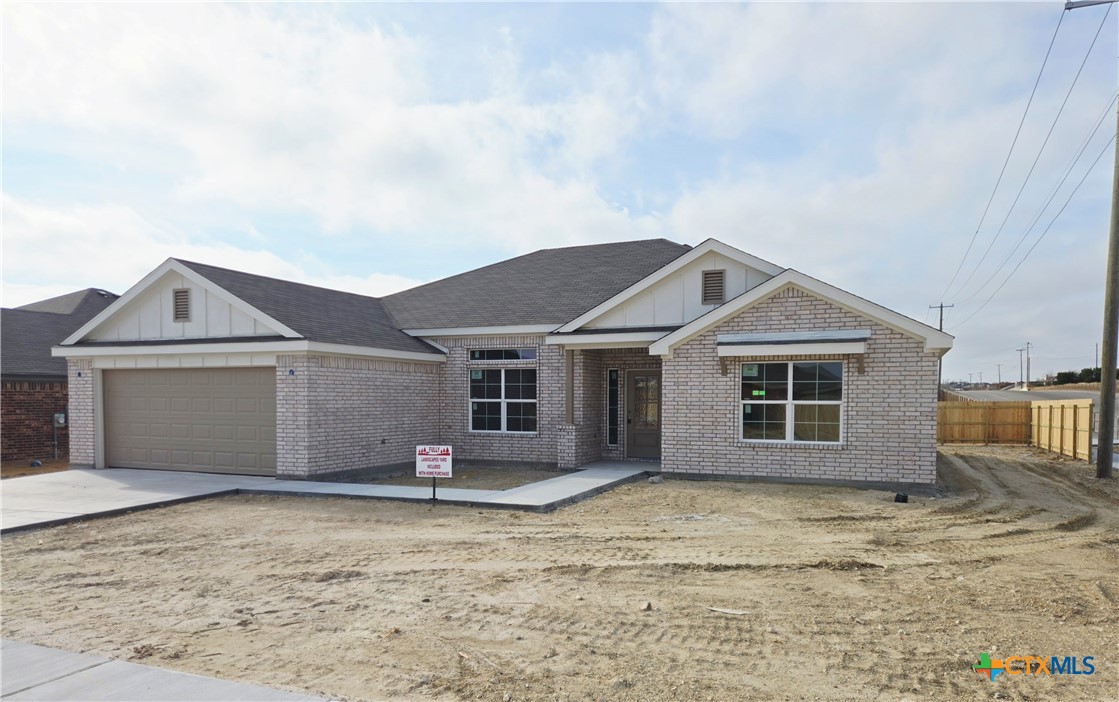3302 Privet Drive Killeen, TX 76549 - Photo 3 of 6 a front view of a house with a yard and garage
