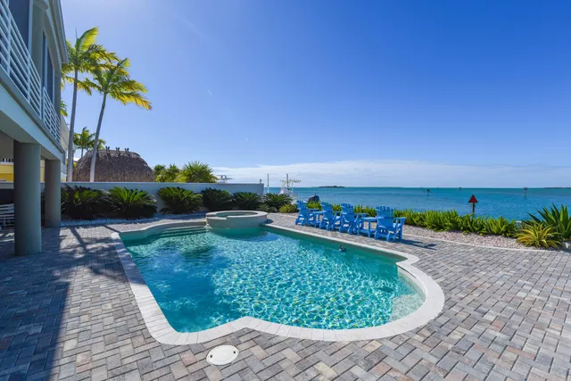 a view of a swimming pool with an outdoor seating