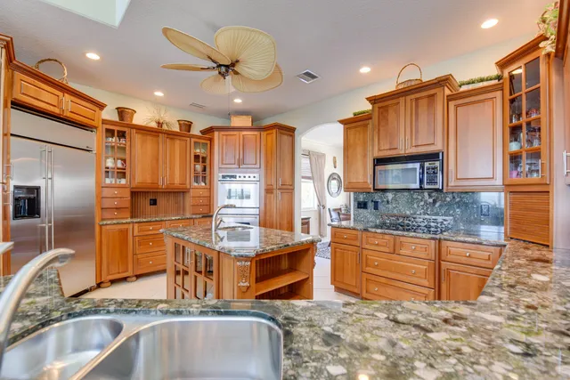 a kitchen with stainless steel appliances granite countertop a sink and cabinets