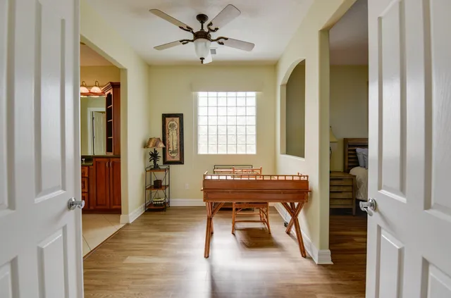 a bedroom with double bed and a potted plant