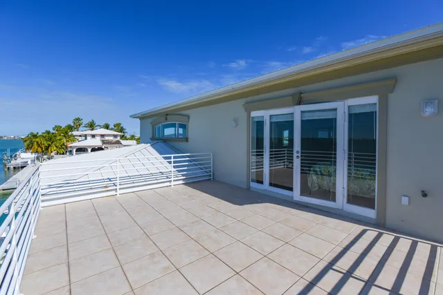 a view of a house with a yard and potted plants