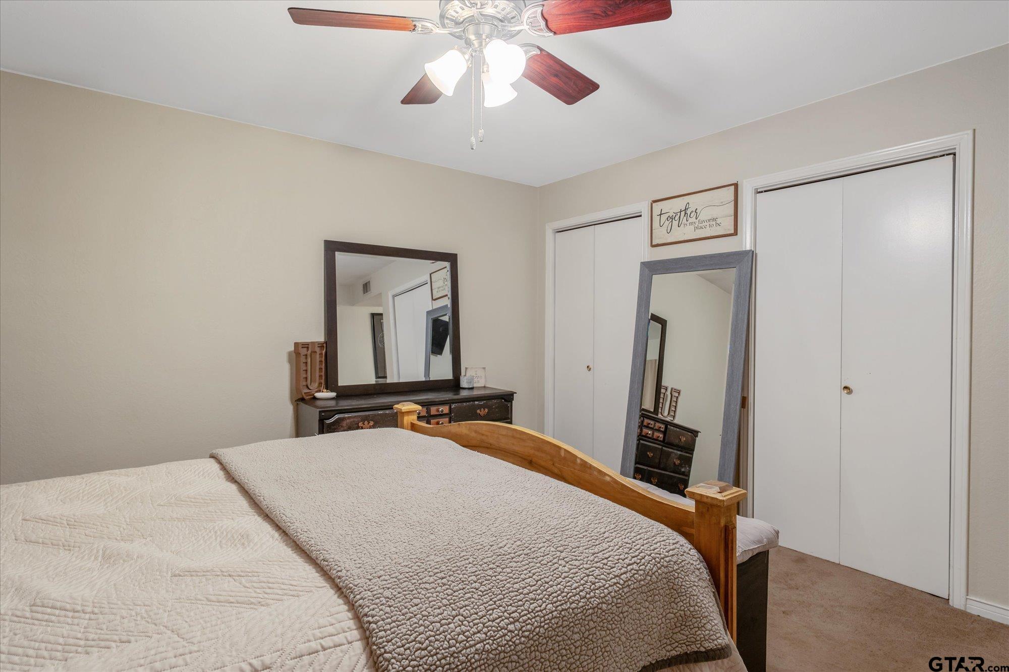 1105 Meadow Drive Athens, TX 75751 - Photo 11 of 23 a bedroom with a bed and a chandelier