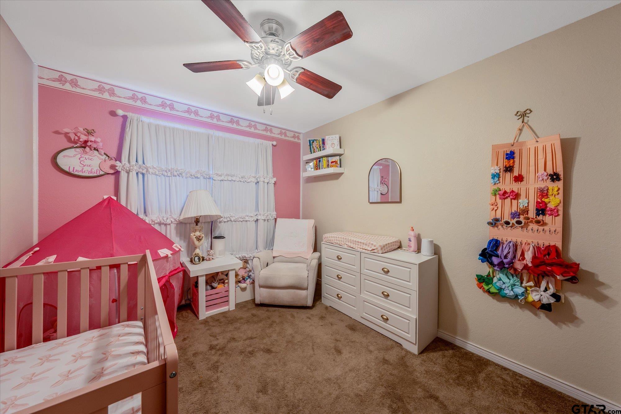 1105 Meadow Drive Athens, TX 75751 - Photo 13 of 23 a living room with furniture a baby crib and a couch