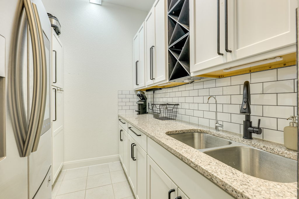 4209 Brean Down Road Pflugerville, TX 78660 - Photo 8 of 31 Functional buttler's pantry prep area offers granite counters, double sinks, and integrated wine storage.