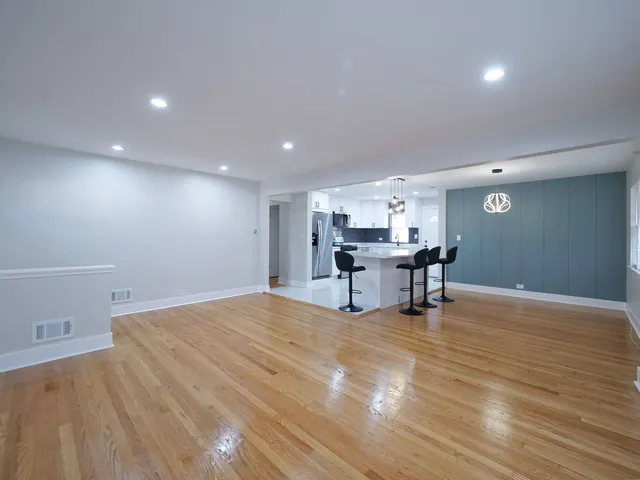 a big room with wooden floor and furniture