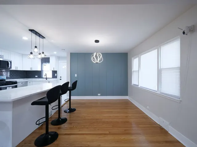 a view of kitchen with windows and wooden floors