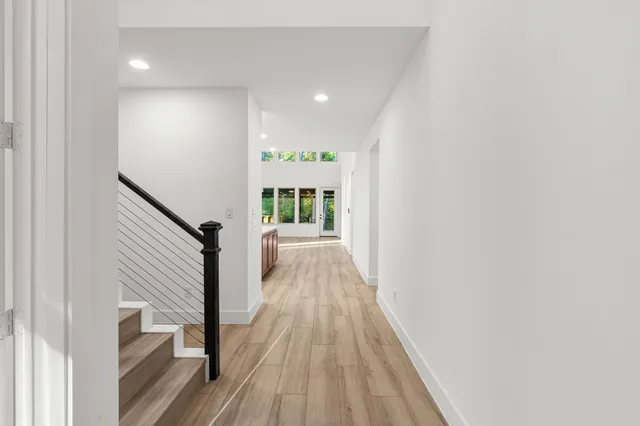 a view of entryway and hall with wooden floor