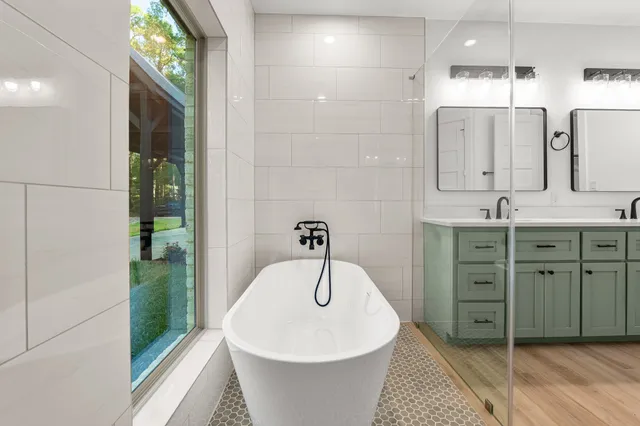 a bathroom with a tub and shower