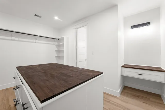 a bathroom with a double vanity sink mirror and toilet