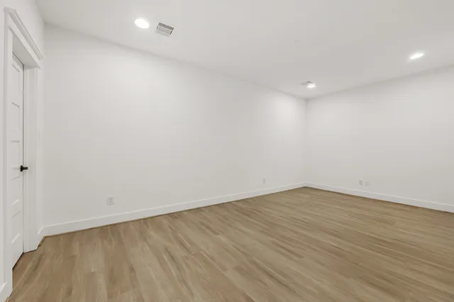 a swimming pool with potted plants and large trees