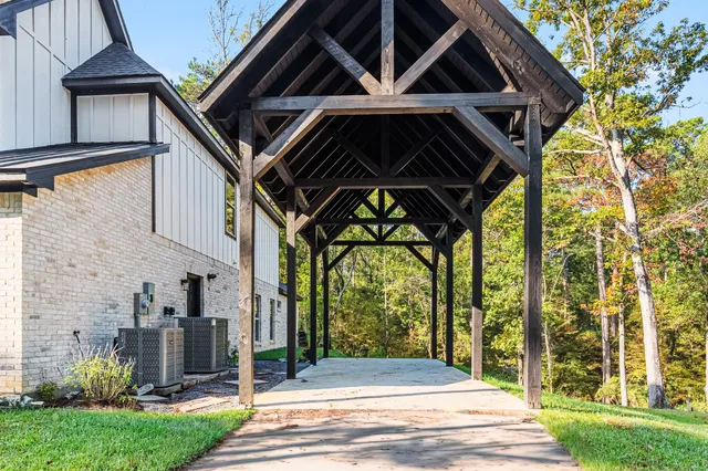 a view of a house with yard and a tree