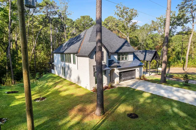 a kitchen with a sink a counter top space and living room view