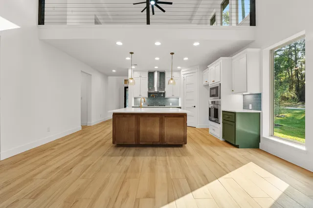 a kitchen with a stove and a wooden floor