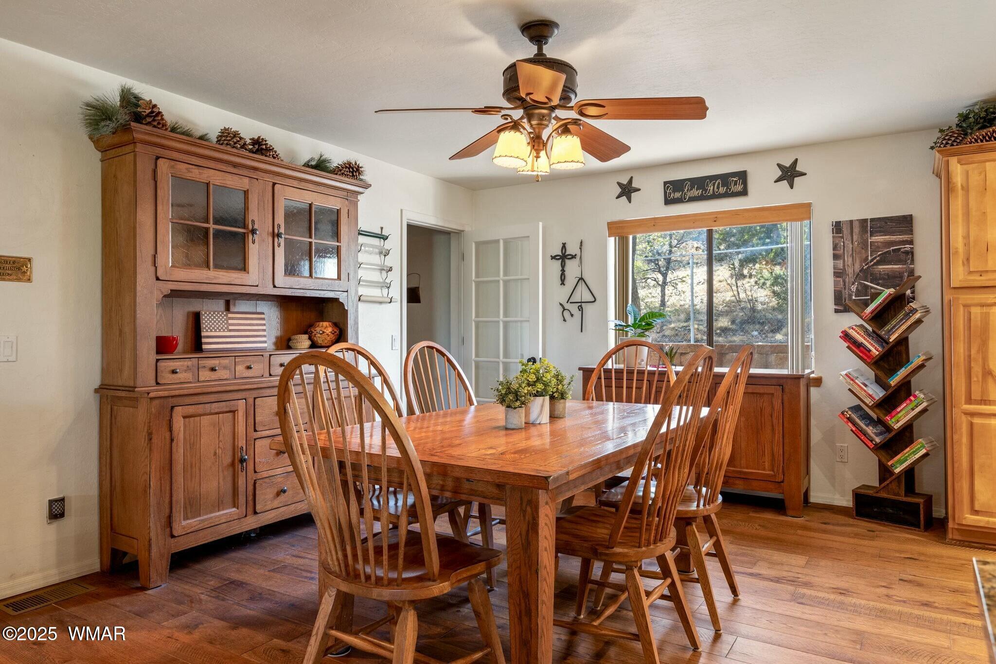 2938 Lodgepole Road Overgaard, AZ 85933 - Photo 11 of 43 a view of a dining room with furniture window and wooden floor