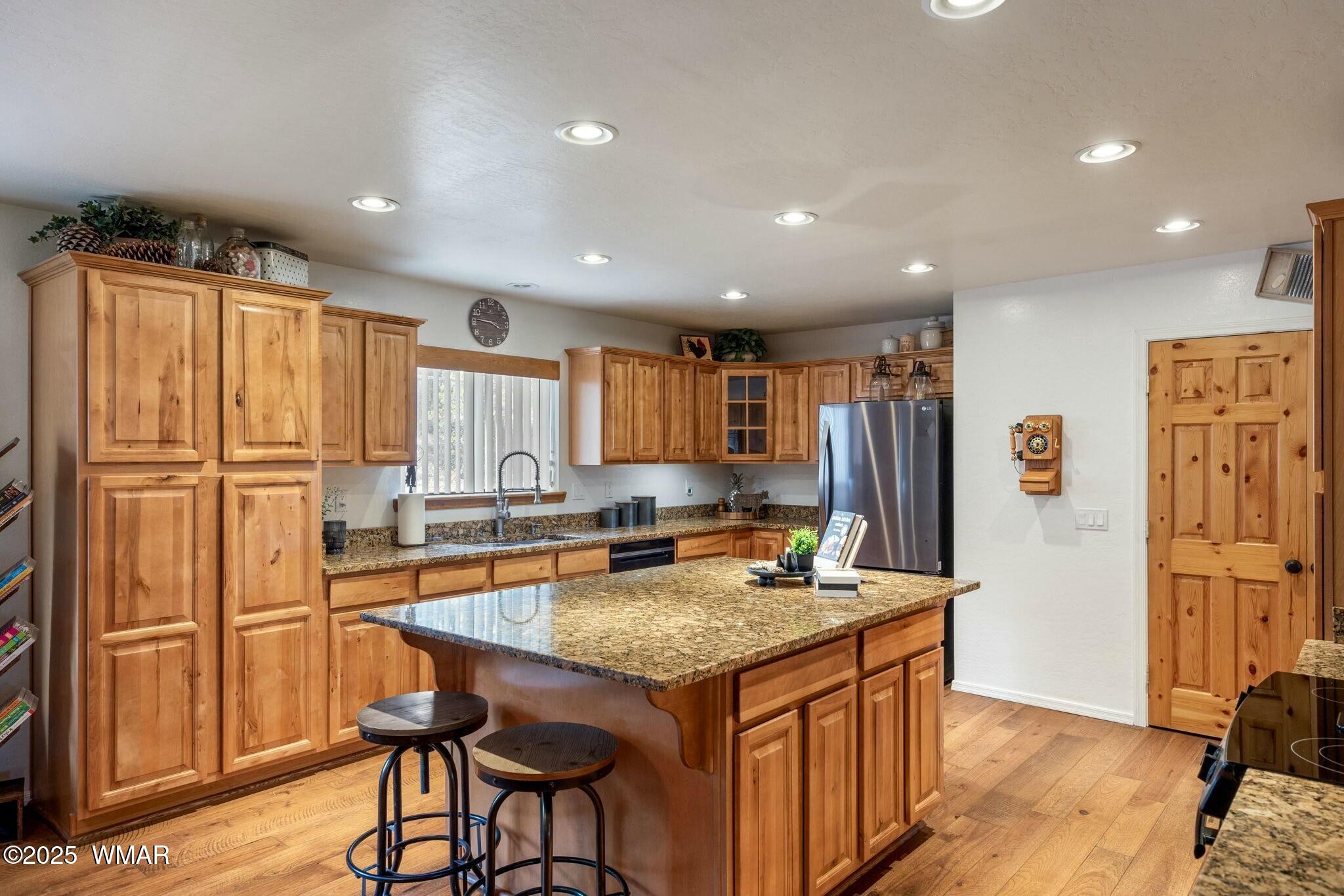 2938 Lodgepole Road Overgaard, AZ 85933 - Photo 12 of 43 a kitchen with stainless steel appliances granite countertop a refrigerator and a stove top oven