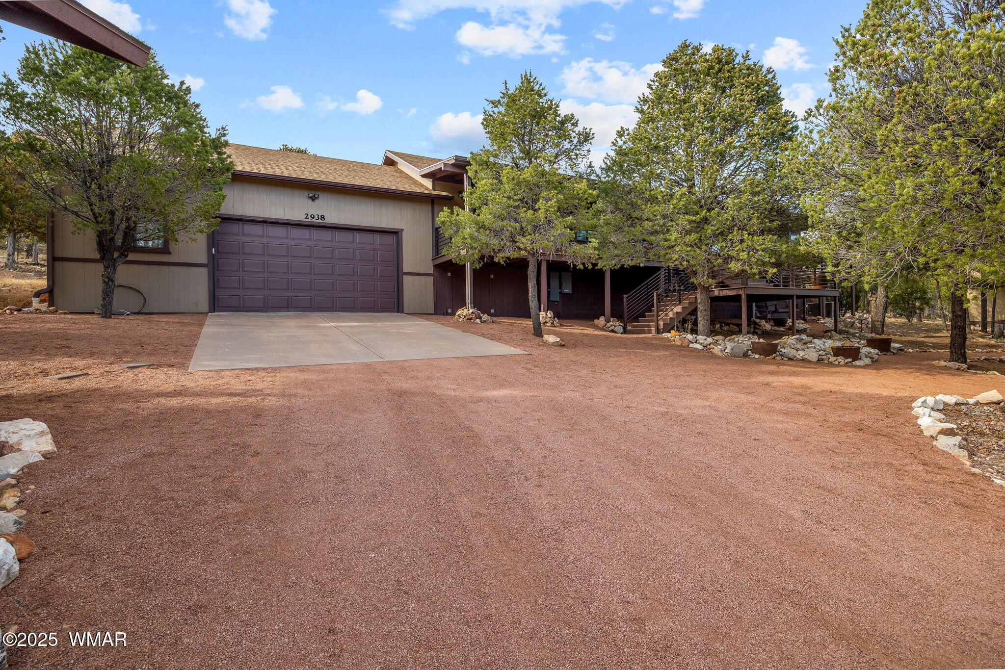 2938 Lodgepole Road Overgaard, AZ 85933 - Photo 2 of 43 a front view of a building with trees