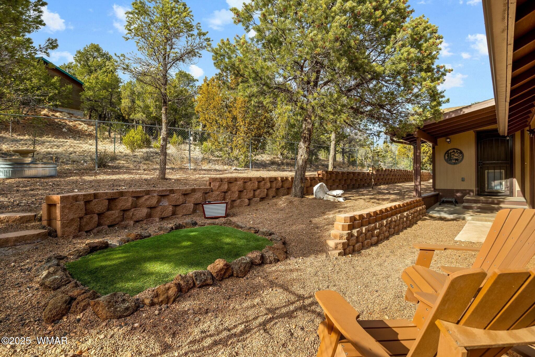 2938 Lodgepole Road Overgaard, AZ 85933 - Photo 30 of 43 a view of a backyard with a sitting area